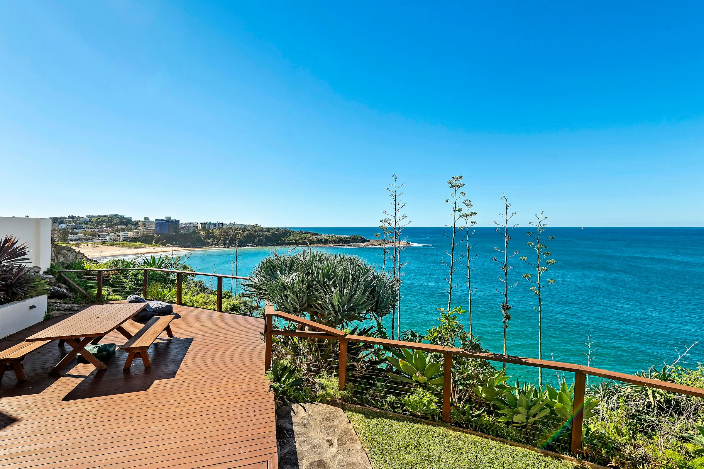 A timber deck overlooking the ocean on a clear day